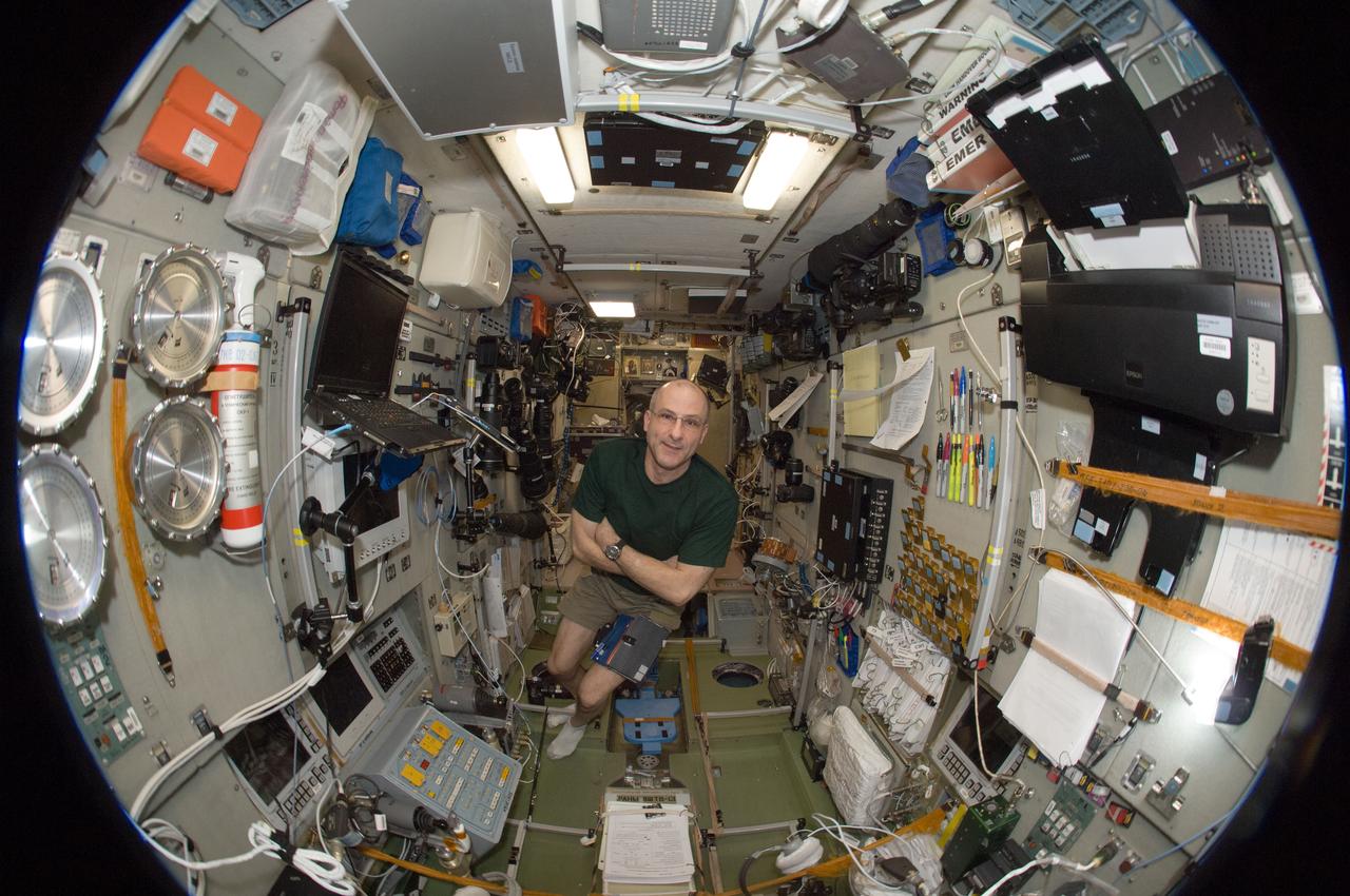ISS031-E-030486 (12 May 2012) --- A fisheye lens attached to an electronic still camera was used to capture this image of NASA astronaut Don Pettit, Expedition 31 flight engineer, in the Zvezda Service Module of the International Space Station.