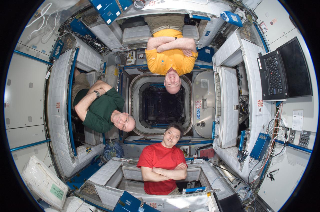 ISS031-E-030602 (12 May 2012) --- A fisheye lens attached to an electronic still camera was used to capture this image of Russian cosmonaut Oleg Kononenko (bottom), Expedition 31 commander; along with NASA astronaut Don Pettit (left) and European Space Agency astronaut Andre Kuipers, both flight engineers, in the Harmony node of the International Space Station.