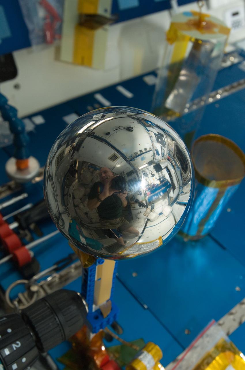 ISS031-E-035391 (12 May 2012) --- NASA astronaut Don Pettit, Expedition 31 flight engineer, took this picture of a four-inch polished metal sphere in the International Space Station’s Destiny laboratory on May 12, 2012 using a 28mm lens. A close look of the sphere reveals a mirrored Pettit.