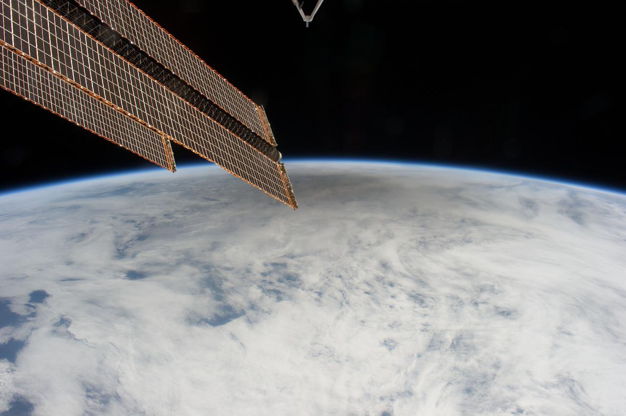 ISS031-E-41594 (20 May 2012) --- This is one of a series of photos taken by Expedition 31 Flight Engineer Don Pettit aboard the International Space Station, showing a shadow of the moon created by the May 20 solar eclipse, as the shadow spreads across cloud cover on Earth. Pettit used a 28-mm lens on a digital still camera to record the image at 23:35:17 GMT. One of the space station’s solar array panels appears at the top of the frame.