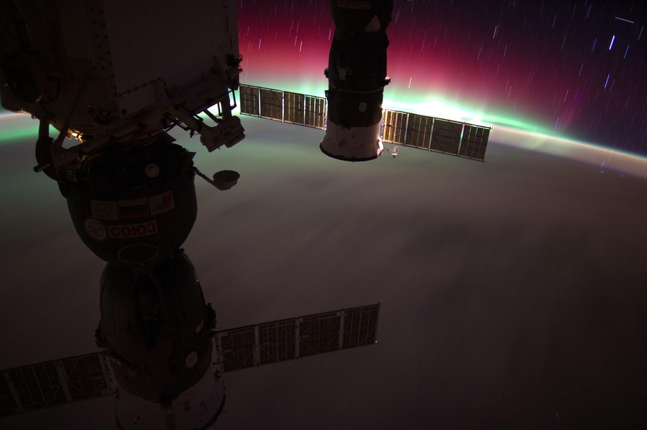 ISS031-E-066041 (22 May 2012) --- This picture, recorded by one of the Expedition 31 crew members aboard the International Space Station, features Aurora Australis with star streaks while the vehicle was over the South Pacific Ocean. The picture was taken when the orbital outpost was above 47.8 degrees south latitude and 179.6 degrees west longitude, about 10 degrees east of southern New Zealand. Two Russian spacecraft are seen in the foreground docked to the station.