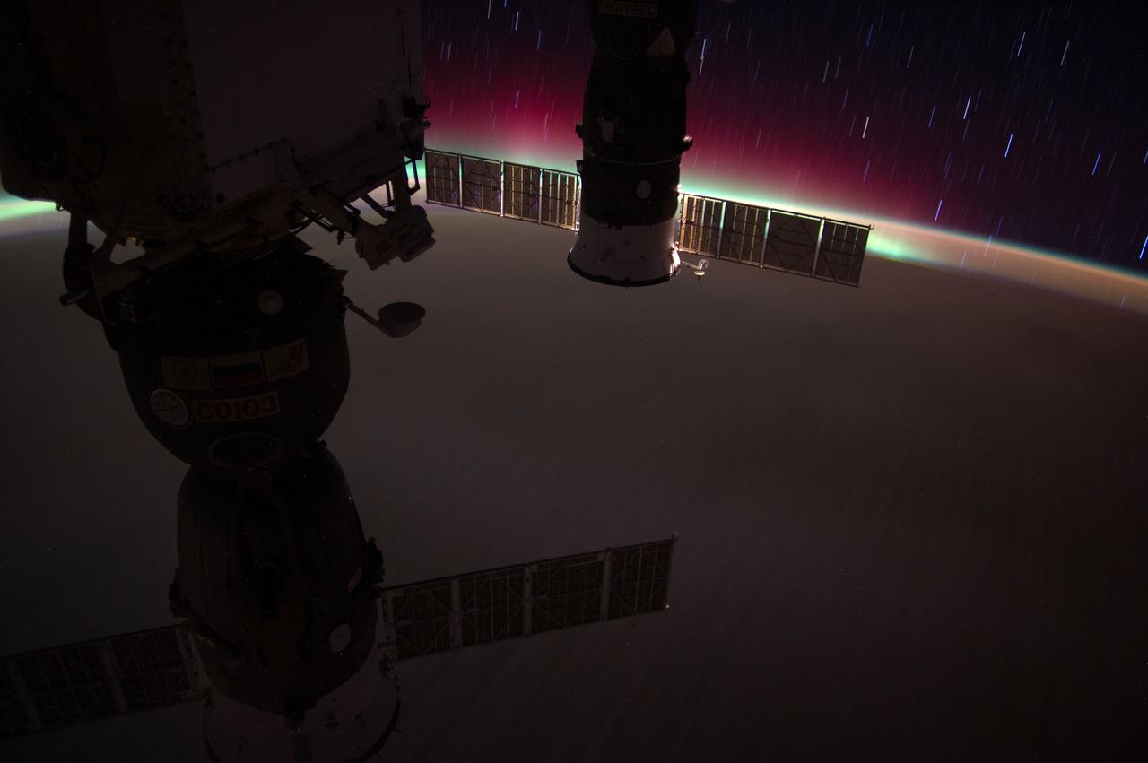 ISS031-E-066053 (22 May 2012) --- Aurora Australis and star streaks over the South Pacific Ocean are featured in this photograph taken by one of the Expedition 31 crew members when the International Space Station was above a point on Earth located at approximately 40.7 degrees south latitude and 162.9 degrees west longitude. Two Russian spacecraft, docked to the station, are seen in the foreground.