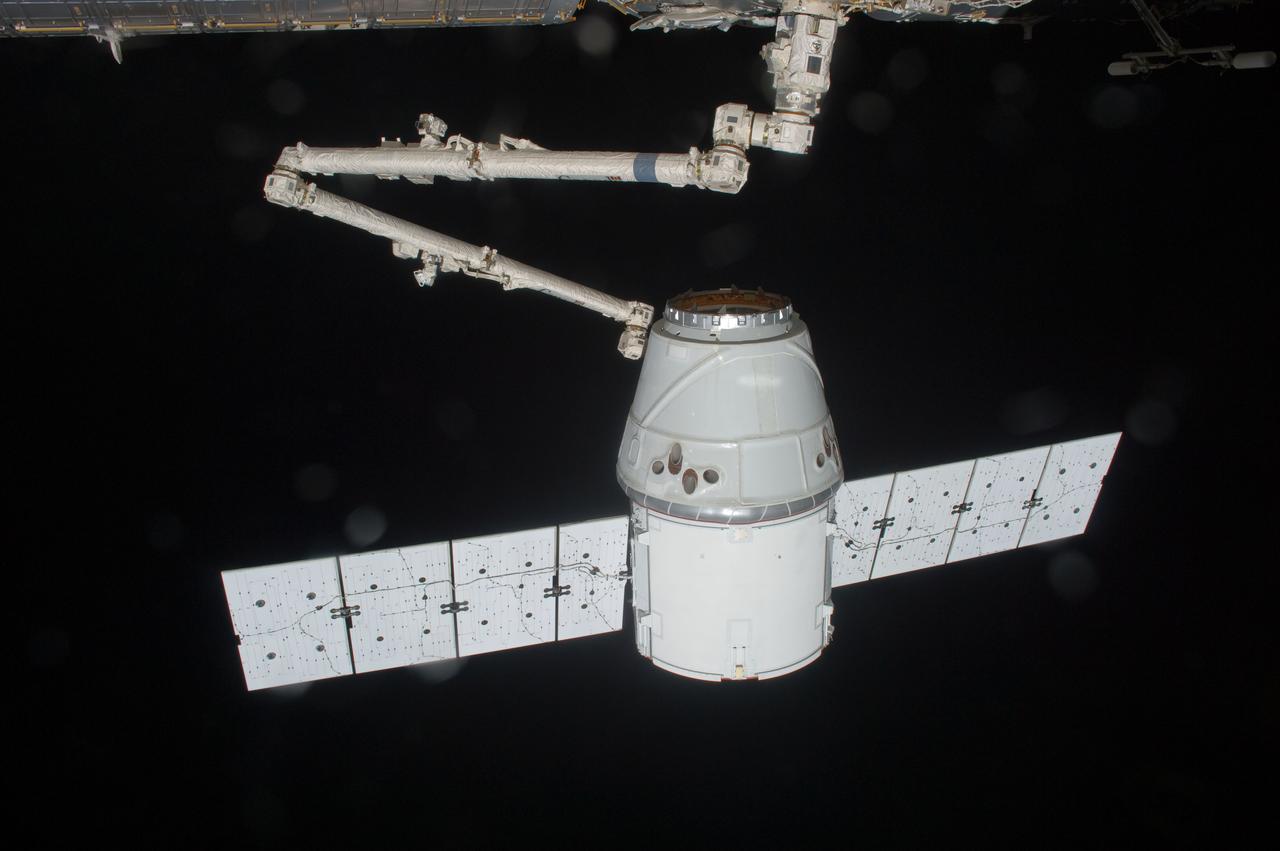ISS031-E-070798 (25 May 2012) --- The SpaceX Dragon commercial cargo craft is grappled by the Canadarm2 robotic arm at the International Space Station. Expedition 31 Flight Engineers Don Pettit and Andre Kuipers grappled Dragon at 9:56 a.m. (EDT) and used the robotic arm to berth Dragon to the Earth-facing side of the station’s Harmony node at 12:02 p.m. May 25, 2012. Dragon became the first commercially developed space vehicle to be launched to the station to join Russian, European and Japanese resupply craft that service the complex while restoring a U.S. capability to deliver cargo to the orbital laboratory. Dragon is scheduled to spend about a week docked with the station before returning to Earth on May 31 for retrieval.