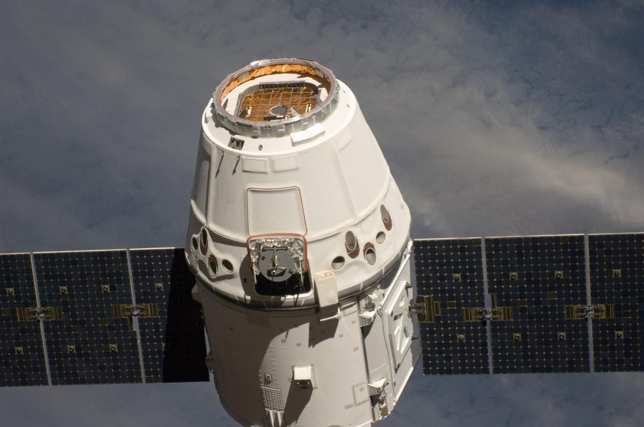 ISS031-E-071143 (25 May 2012) --- The SpaceX Dragon commercial cargo craft approaches the International Space Station on May 25, 2012 for grapple and berthing. Expedition 31 Flight Engineers Don Pettit and Andre Kuipers grappled Dragon at 9:56 a.m. (EDT) with the Canadarm2 robotic arm and used the robotic arm to berth Dragon to the Earth-facing side of the station’s Harmony node at 12:02 p.m. May 25, 2012. Dragon became the first commercially developed space vehicle to be launched to the station to join Russian, European and Japanese resupply craft that service the complex while restoring a U.S. capability to deliver cargo to the orbital laboratory. Dragon is scheduled to spend about a week docked with the station before returning to Earth on May 31 for retrieval.