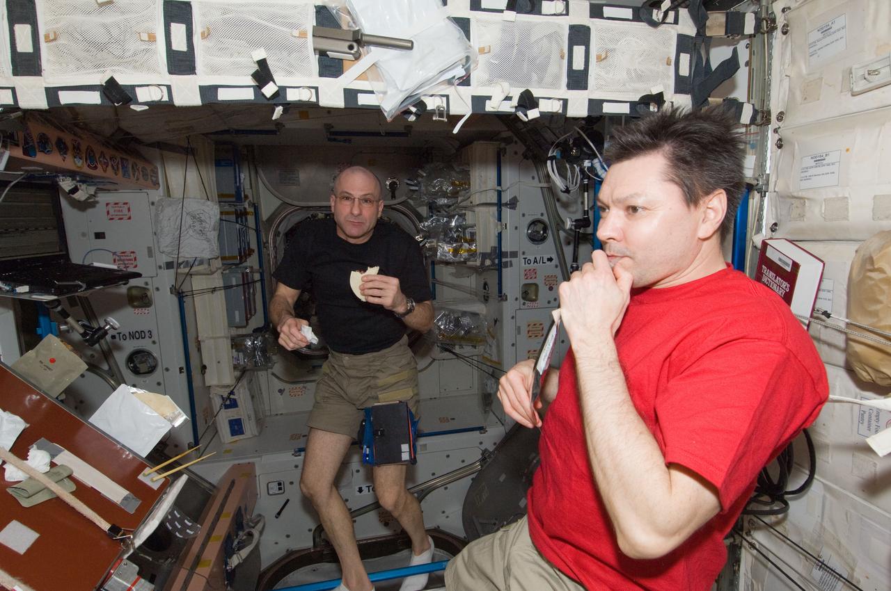 ISS031-E-077526 (13 May 2012) --- Russian cosmonaut Oleg Kononenko (right), Expedition 31 commander; and NASA astronaut Don Pettit, flight engineer, enjoy a snack in the Unity node of the International Space Station.
