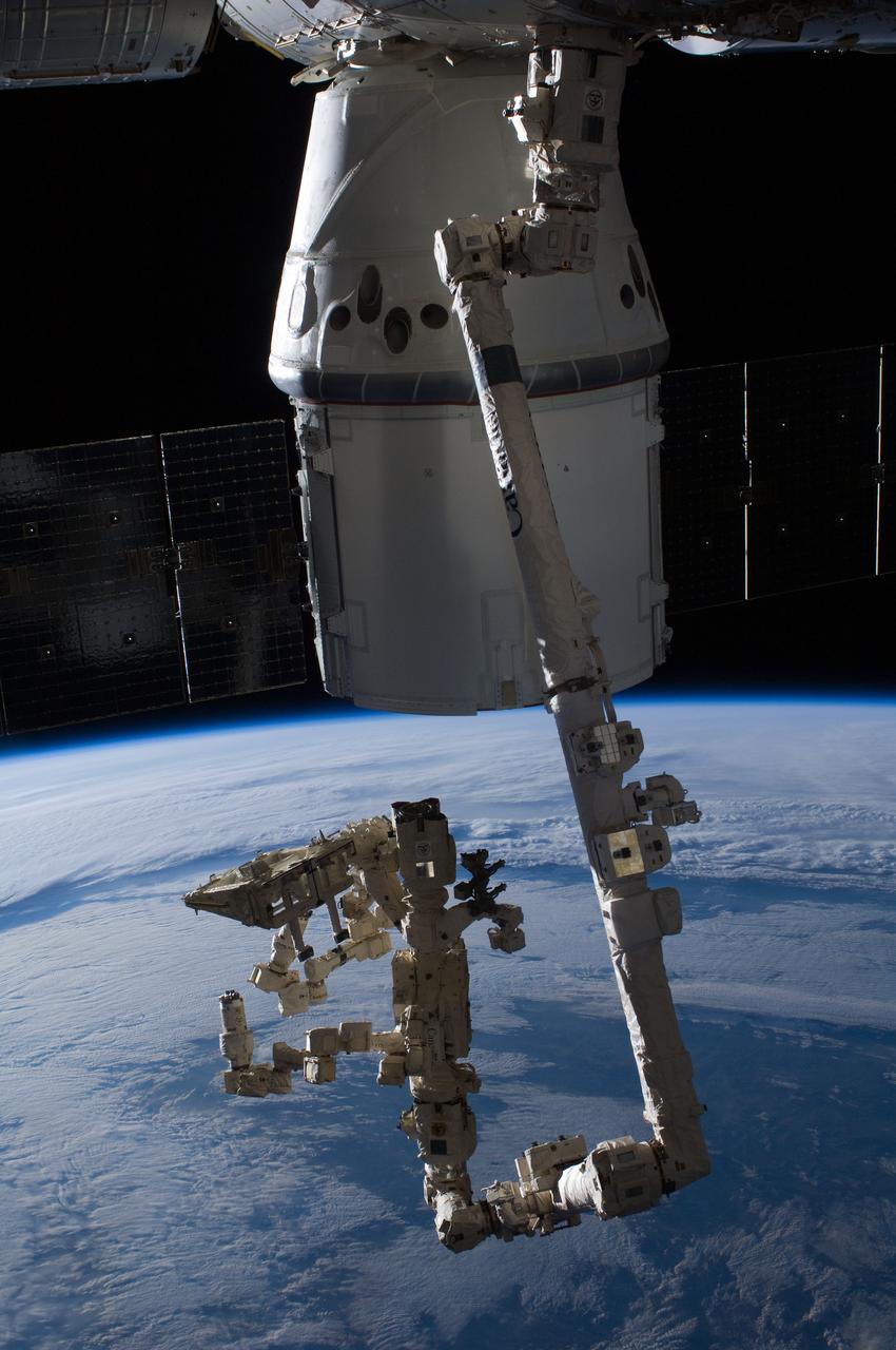 ISS031-E-077562 (25 May 2012) --- The SpaceX Dragon commercial cargo craft is berthed to the Earth-facing side of the International Space Station’s Harmony node. Expedition 31 Flight Engineers Don Pettit and Andre Kuipers grappled Dragon at 9:56 a.m. (EDT) with the Canadarm2 robotic arm and used it to berth Dragon to the at 12:02 p.m. May 25, 2012. Dragon became the first commercially developed space vehicle to be launched to the station to join Russian, European and Japanese resupply craft that service the complex while restoring a U.S. capability to deliver cargo to the orbital laboratory. Dragon is scheduled to spend about a week docked with the station before returning to Earth on May 31 for retrieval.
