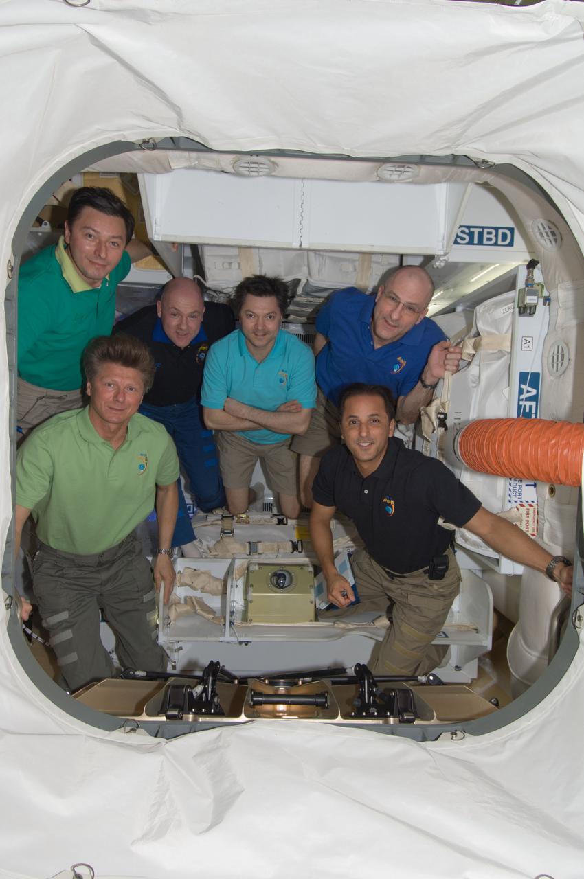 ISS031-E-078299 (29 May 2012) --- Expedition 31 crew members pose for an in-flight crew portrait inside the SpaceX Dragon cargo craft currently attached to the International Space Station. Pictured clockwise (from the left) are Russian cosmonauts Gennady Padalka and Sergei Revin, European Space Agency astronaut Andre Kuipers, all flight engineers; Russian cosmonaut Oleg Kononenko, commander; NASA astronauts Don Pettit and Joe Acaba, both flight engineers. The SpaceX Falcon 9 and its Dragon spacecraft launched at 3:44 a.m. (EDT) on May 22. This mission is a demonstration flight by Space Exploration Technologies, or SpaceX, as part of its contract with NASA to have private companies launch cargo safely to the International Space Station.