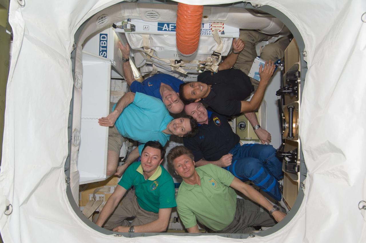 ISS031-E-078305 (29 May 2012) --- Expedition 31 crew members pose for an in-flight crew portrait inside the SpaceX Dragon cargo craft currently attached to the International Space Station. Pictured clockwise (from left center) are Russian cosmonaut Oleg Kononenko, commander; along with NASA astronauts Don Pettit and Joe Acaba, European Space Agency astronaut Andre Kuipers, Russian cosmonauts Gennady Padalka and Sergei Revin, all flight engineers. The SpaceX Falcon 9 and its Dragon spacecraft launched at 3:44 a.m. (EDT) on May 22. This mission is a demonstration flight by Space Exploration Technologies, or SpaceX, as part of its contract with NASA to have private companies launch cargo safely to the International Space Station.