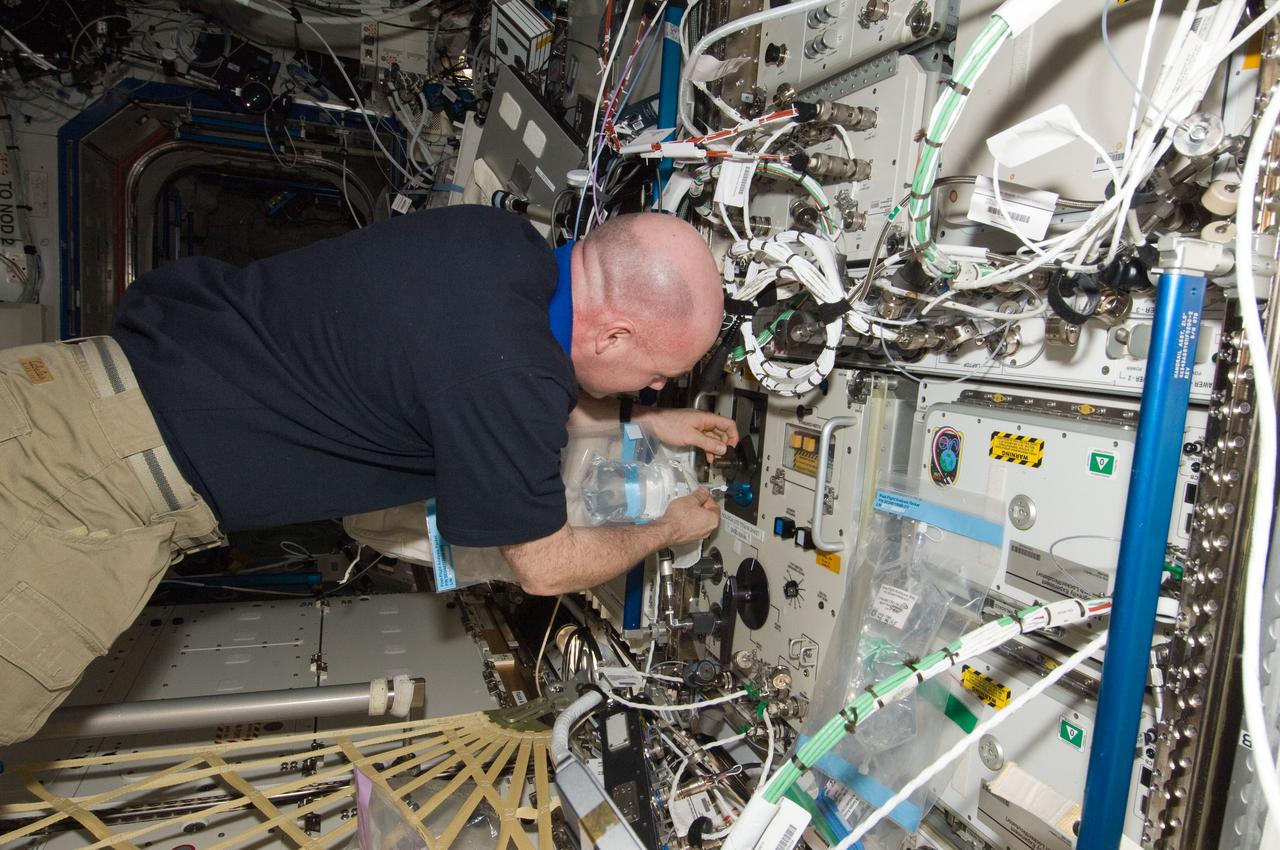 ISS031-E-079015 (15 May 2012) --- European Space Agency astronaut Andre Kuipers, Expedition 31 flight engineer, collects a sample from the Water Recovery System (WRS) in the Destiny laboratory of the International Space Station.