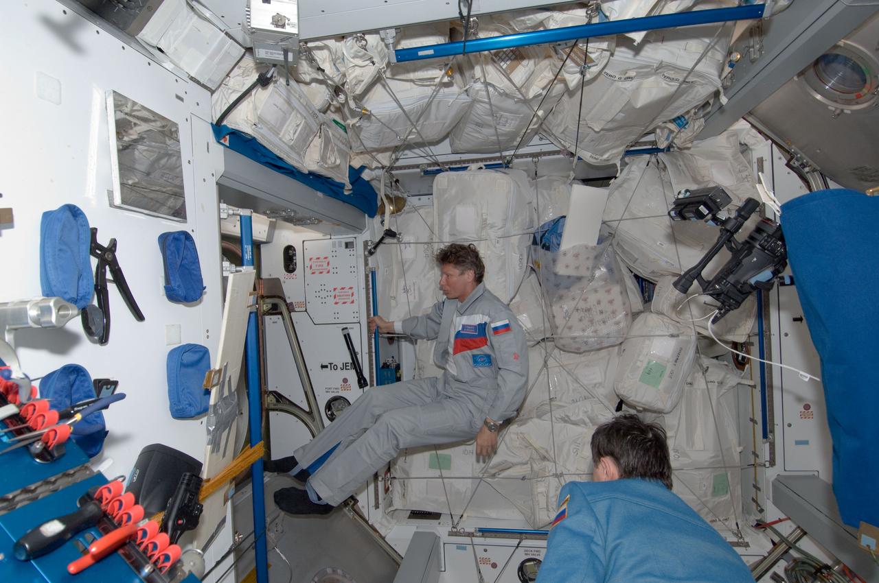 ISS031-E-081649 (17 May 2012) --- Russian cosmonauts Gennady Padalka (background) and Sergei Revin, both Expedition 31 flight engineers, are pictured in the Harmony node of the International Space Station shortly after Padalka, Revin and NASA astronaut Joe Acaba (not pictured) docked with the space station in their Soyuz TMA-04M spacecraft.