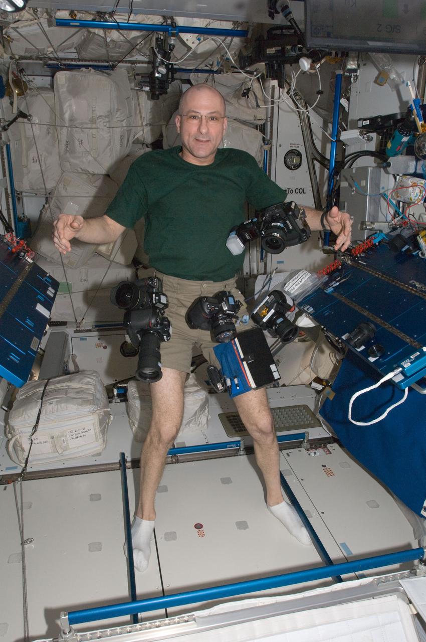 ISS031-E-081812 (31 May 2012) --- NASA astronaut Don Pettit, Expedition 31 flight engineer, is pictured near several still cameras floating freely in the Harmony node of the International Space Station.