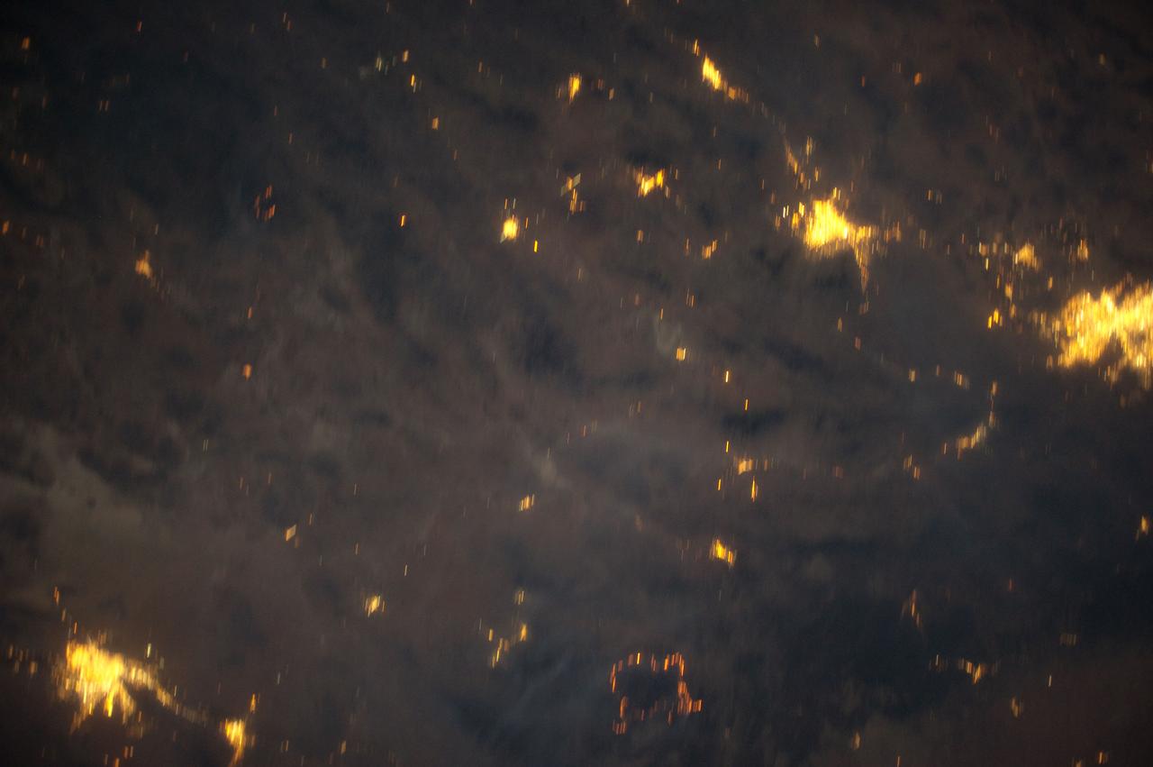 ISS031-E-83747  (2 June 2012) ---  Downlinked from the International Space Station this still  image -– part of a series from a mounted, automated, twilight session -- when viewed in sequence shows the flame ring associated with wild fires in the Southwest move from bottom to top-center framed at a distance by the bright urban areas of Tucson, Phoenix, El Paso-Las Cruces, and finally Albuquerque (mostly under cloud).