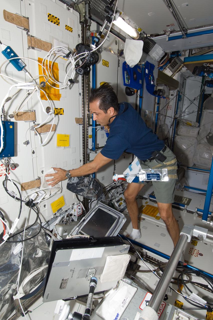 ISS031-E-095918 (8 June 2012) --- NASA astronaut Joe Acaba, Expedition 31 flight engineer, cleans surface areas in the Tranquility node of the International Space Station.