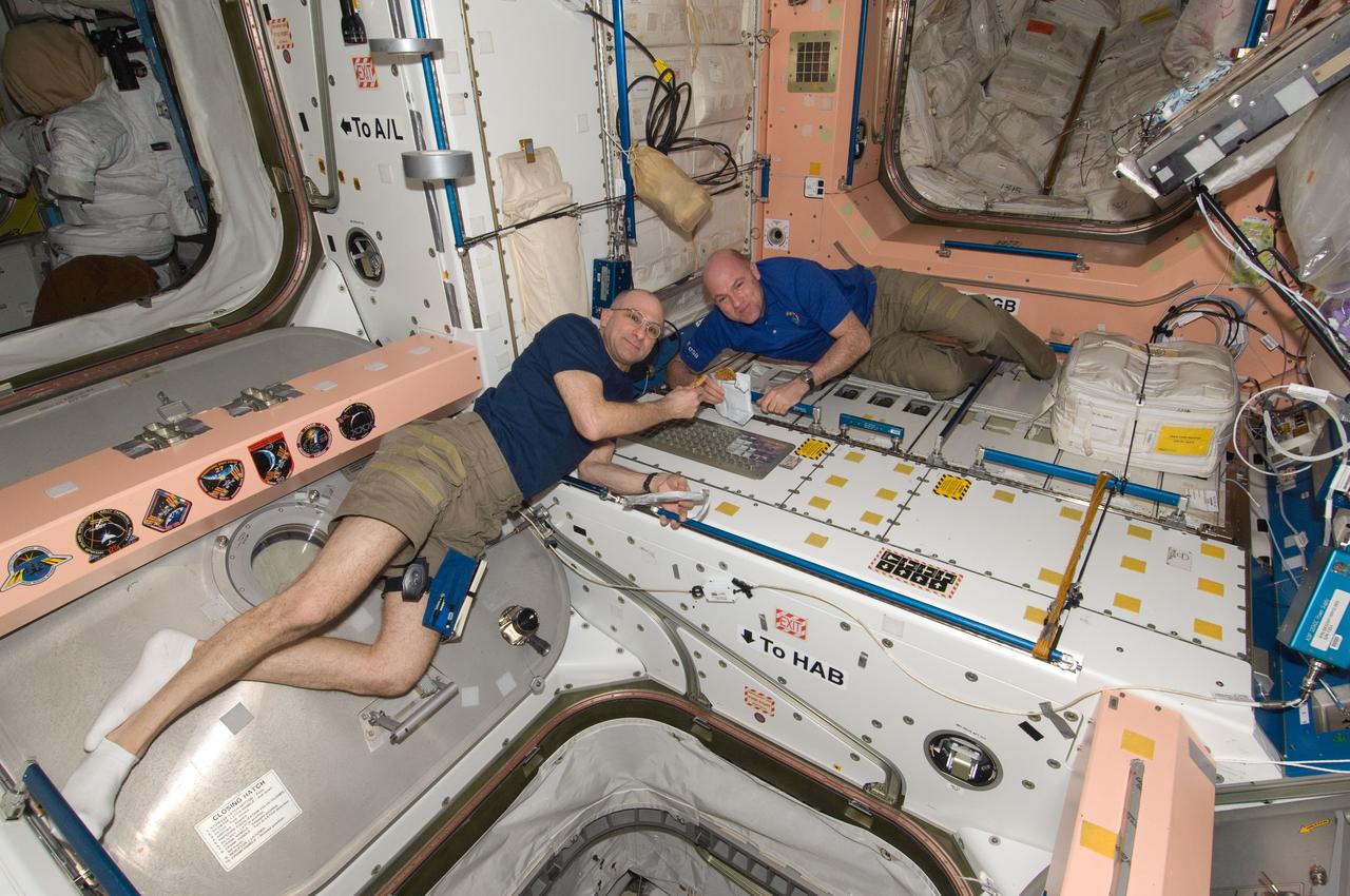 ISS031-E-095943 (9 June 2012) --- NASA astronaut Don Pettit (left) and European Space Agency astronaut Andre Kuipers, both Expedition 31 flight engineers, eat a snack in the Unity node of the International Space Station.