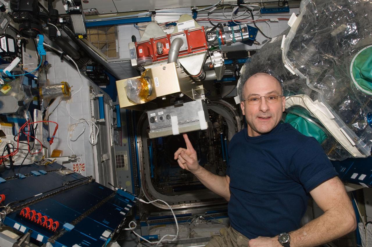 ISS031-E-096083 (8 June 2012) --- NASA astronaut Don Pettit, Expedition 31 flight engineer, poses for a photo with the Amine Swingbed Power Handler Unit during scheduled in-flight maintenance in the Harmony node of the International Space Station.