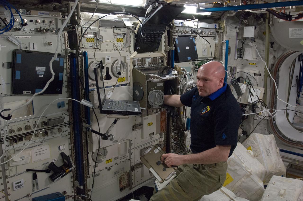 ISS031-E-140316 (18 May 2012) --- European Space Agency astronaut Andre Kuipers, Expedition 31 flight engineer, supports a ground-conducted health check on ESA’s Biolab Glovebox in the Columbus laboratory of the International Space Station.