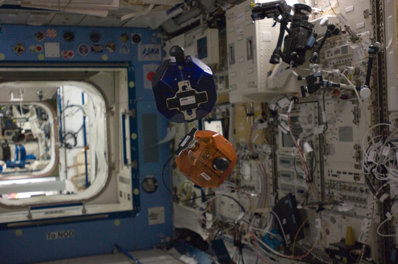 ISS031-E-140672 (22 June 2012) --- Two bowling-ball-sized free-flying satellites called Synchronized Position Hold, Engage, Reorient, Experimental Satellites Zero Robotics (SPHERES ZR) are pictured during a test session in the Kibo laboratory of the International Space Station.