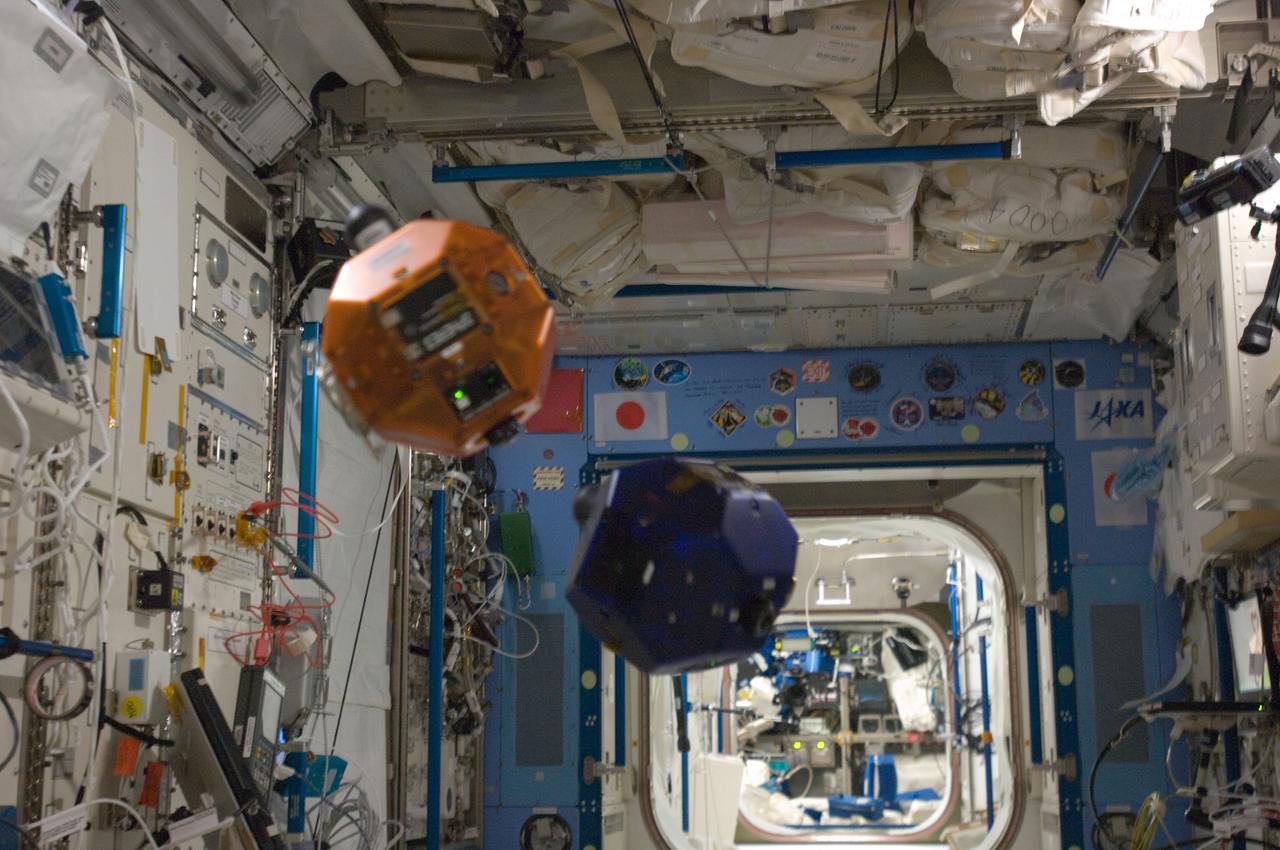 ISS031-E-140676 (22 June 2012) --- Two bowling-ball-sized free-flying satellites called Synchronized Position Hold, Engage, Reorient, Experimental Satellites Zero Robotics (SPHERES ZR) are pictured during a test session in the Kibo laboratory of the International Space Station.