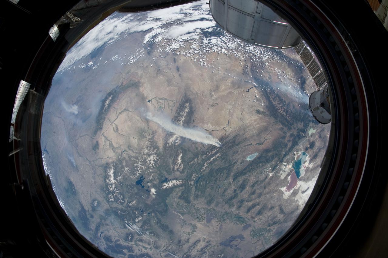 ISS031-E-146344 (27 June 2012) --- An Expedition 31 crew member aboard the International Space Station, flying approximately 240 miles above Earth, recorded a series of images of the current wild fires in the southwestern United States.  For this particular image, taken from the station?s Cupola, he used a 16mm lens, which gives this view a ?fisheye? affect. The fires give rise to thick smoke plumes on the southernmost extremity of the Wyoming Range, which occupies the center of the image. Slopes of the central Salt River Range appear at left. Three helicopters and more than 100 personnel are fighting the fire, which is being managed by the Bridger?Teton National Forest.