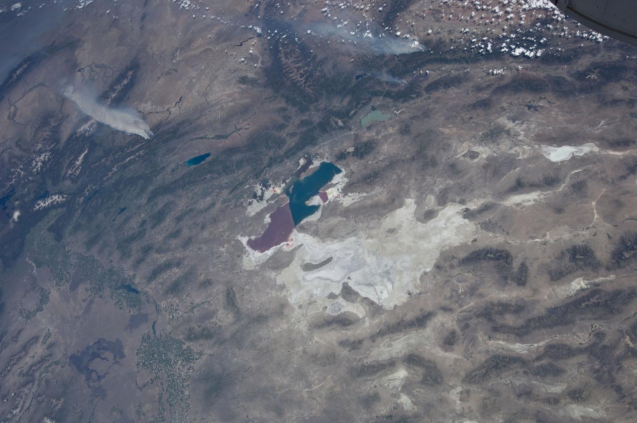 ISS031-E-146397 (27 June 2012) --- An Expedition 31 crew member aboard the International Space Station, flying approximately 240 miles above Earth, recorded a series of images of the current wild fires in the western and southwestern United States. These particular fires, of unknown cause, are burning at the south end of the Wyoming Range in southwestern Wyoming, and have affected 17,000 acres. The fires have produced two major smoke plumes, seen at upper left of the 18mm frame. Winds transport the smoke in a northeasterly direction. Utah?s Great Salt Lake (center) is about 120 miles away. Bear Lake and Utah Lake (very light blue or gray) are also visible in the frame.