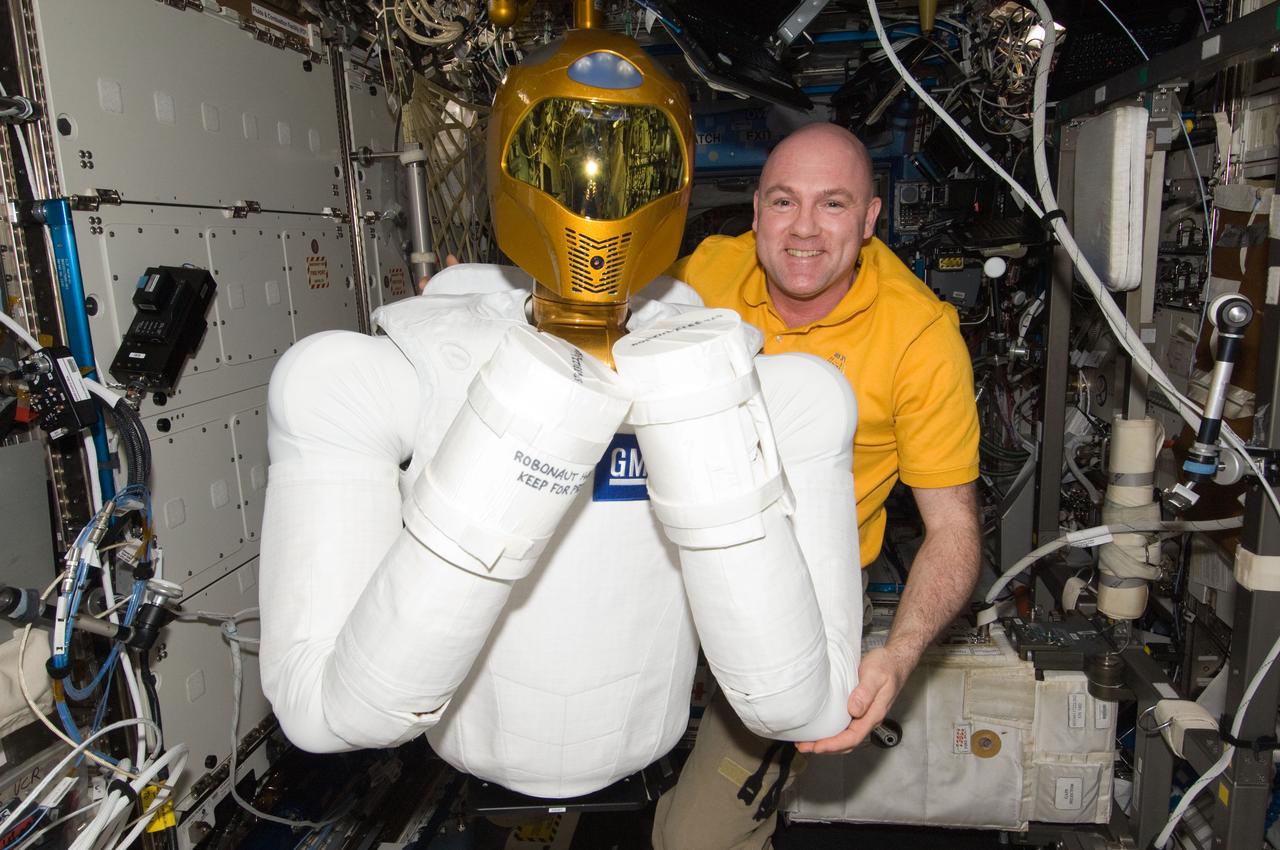 ISS031-E-148737 (27 June 2012) --- European Space Agency astronaut Andre Kuipers, Expedition 31 flight engineer, poses for a photo with Robonaut 2 humanoid robot in the Destiny laboratory of the International Space Station.
