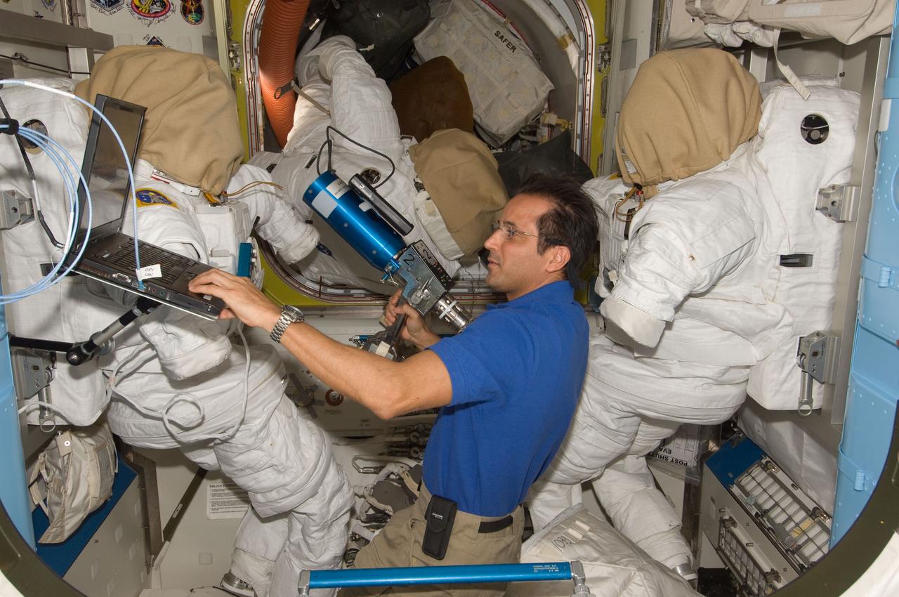 ISS031-E-149757 (28 June 2012) --- NASA astronaut Joe Acaba, Expedition 31 flight engineer, uses a computer while working with extravehicular activity (EVA) tools in the Quest airlock of the International Space Station.