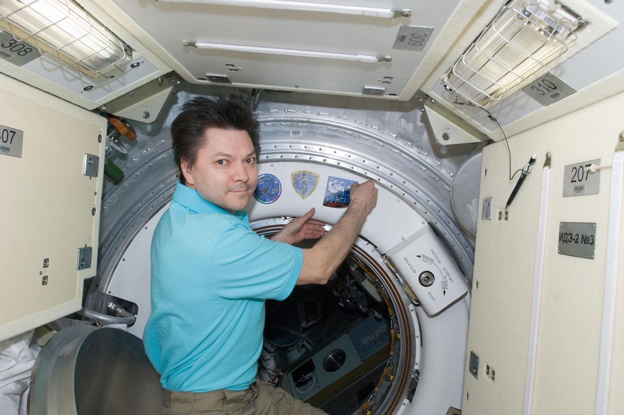 ISS031-E-150060 (28 June 2012) --- In the Rassvet Mini-Research Module 1 (MRM-1),  Russian cosmonaut Oleg Kononenko, Expedition 31 commander, adds the Soyuz TMA-03M patch to the growing collection of insignias representing crews who have worked on the International Space Station.