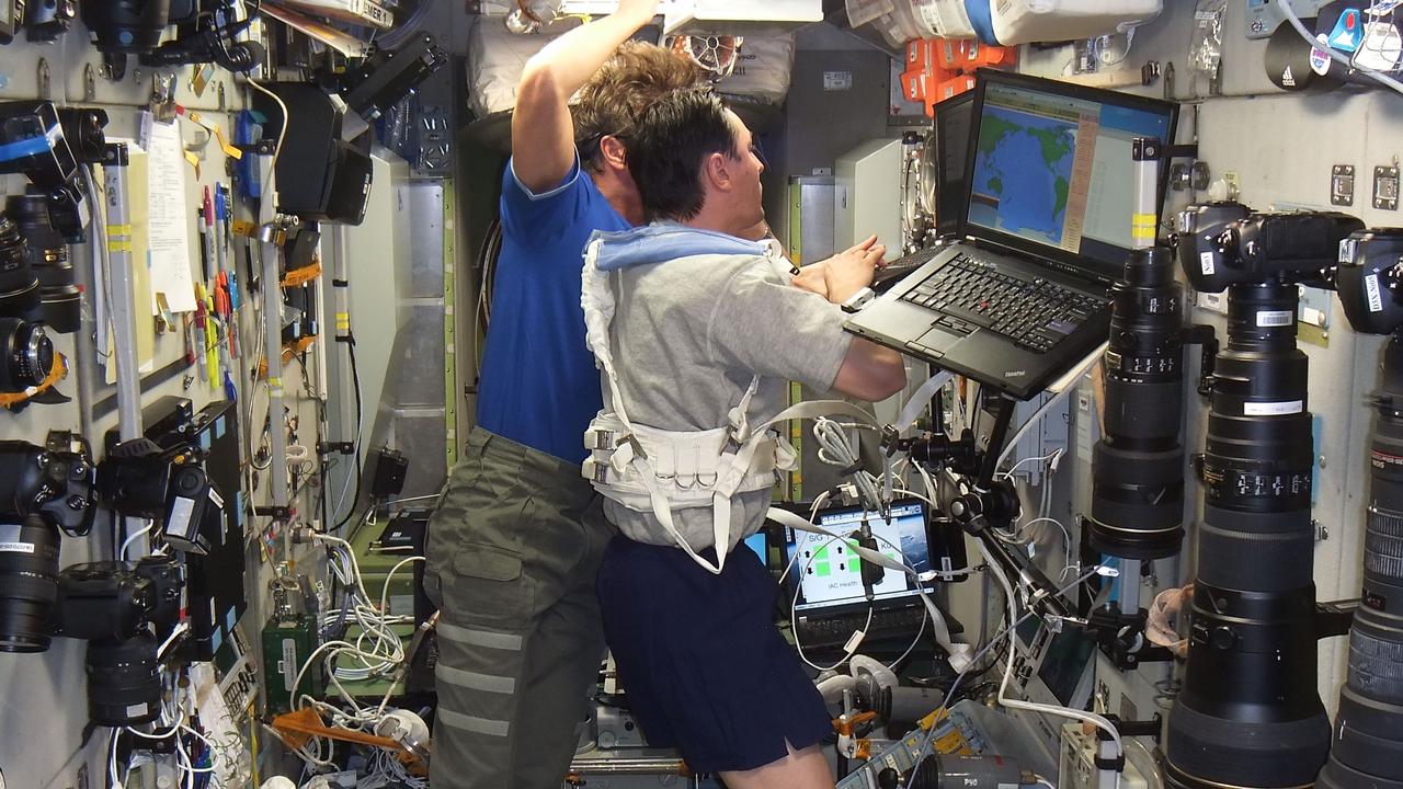 ISS031-E-157809 (22 May 2012) --- Russian cosmonaut Sergei Revin (foreground), Expedition 31 flight engineer, enters data in a computer in the Zvezda Service Module of the International Space Station while Russian cosmonaut Gennady Padalka, flight engineer, looks on.