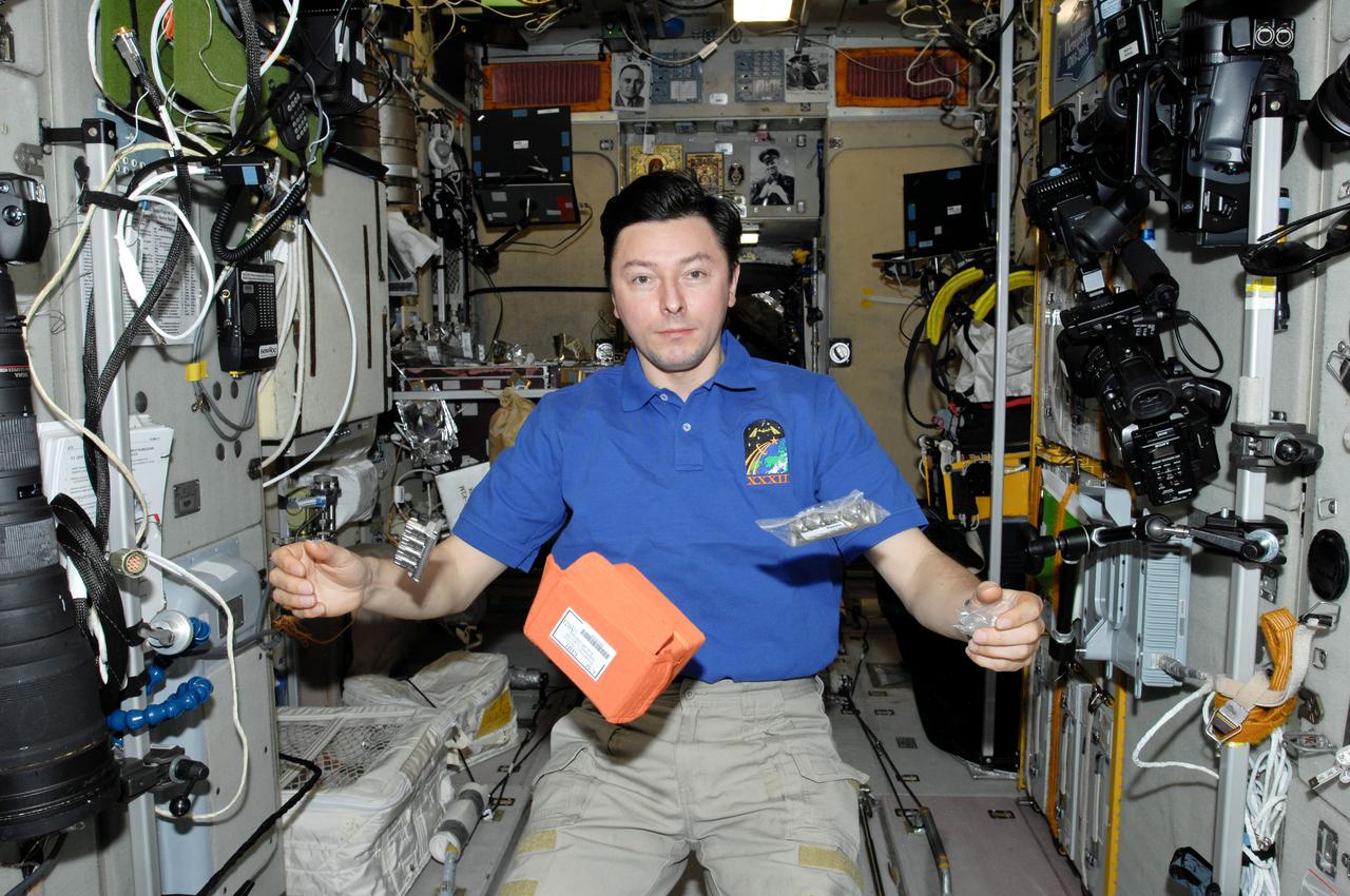 ISS032-E-005012 (30 June 2012) --- Russian cosmonaut Sergei Revin, Expedition 32 flight engineer, is pictured near Russian biotechnology experiment BTKh-26 STRUKTURA (Luch-2) hardware floating freely in the Zvezda Service Module of the International Space Station.