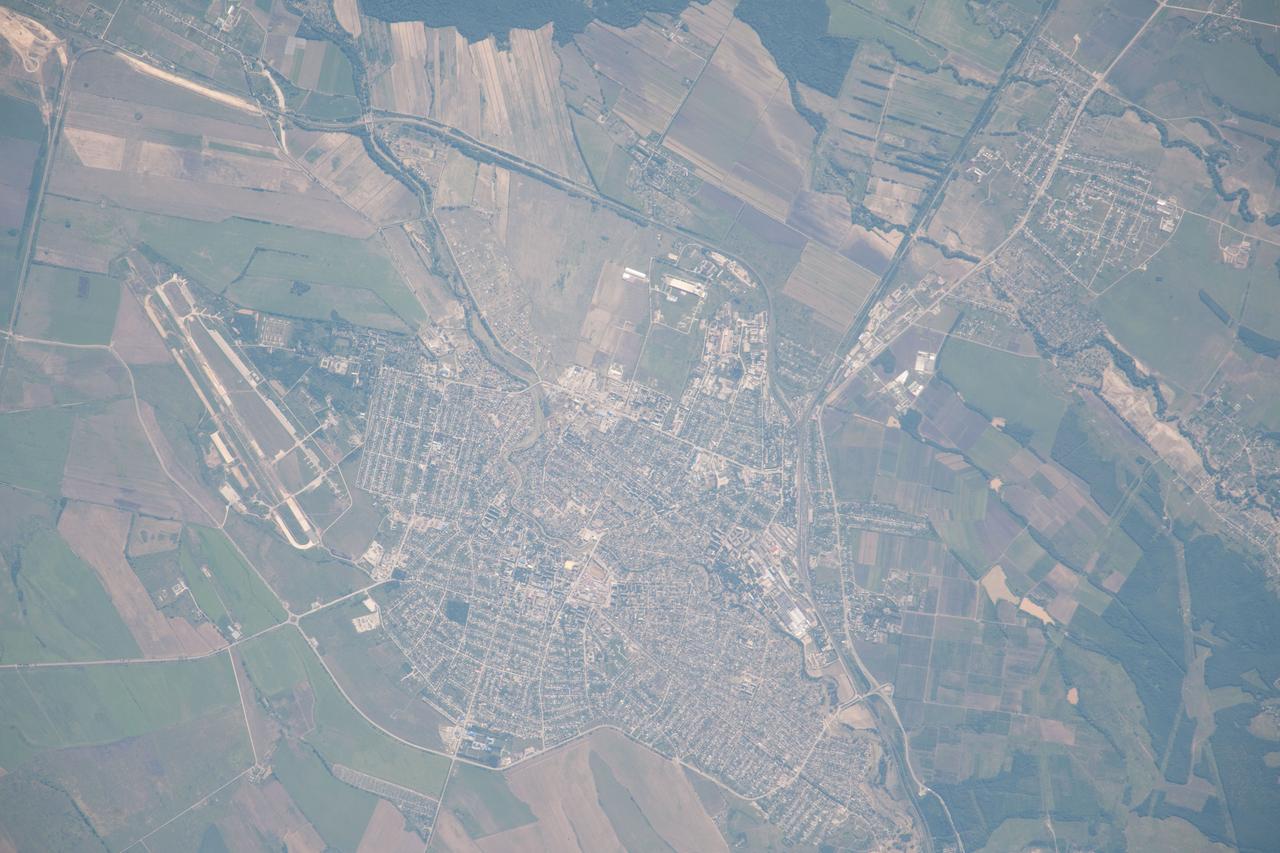 ISS032-E-006129 (10 July 2012) --- Flooding in Krymsk in the Krasnodar region of southern Russia is featured in this image photographed by an Expedition 32 crew member on the International Space Station. On the night of July 7, 2012 a major storm dumped more than a foot of water on the southern Russian area of Krasnodar, near the Black Sea. The resulting flood was likened to a tsunami, and to date, more than 170 people died, most from the city of Krymsk. The Moscow times reports that more than 19,000 people lost everything. This image taken by cosmonauts aboard the space station shows the city of Krymsk. The tan-colored areas indicate some of the regions that were flooded; the color is probably due to the mud and debris that were left by the floodwaters. Krymsk is located in the western foothills on the northern slope of the Caucasus Mountains?a range that stretches between the Black Sea and the Caspian Sea. The vast amount of rain quickly overwhelmed the small river channels that flow northward from the mountains to the Russian lowlands and the Kuban River; Krymsk, located on one of those tributaries, was directly in the pathway of the flash flood. As part of the international partner agreement to use the International Space Station to benefit humanity, crew members and other Earth observing instruments provide best-effort support to the International Disaster Charter (IDC) when it is activated by collecting imagery of areas on the ground impacted by natural events such as the flooding in Krymsk. This image was acquired July 10, 2012 in response to the IDC activation.