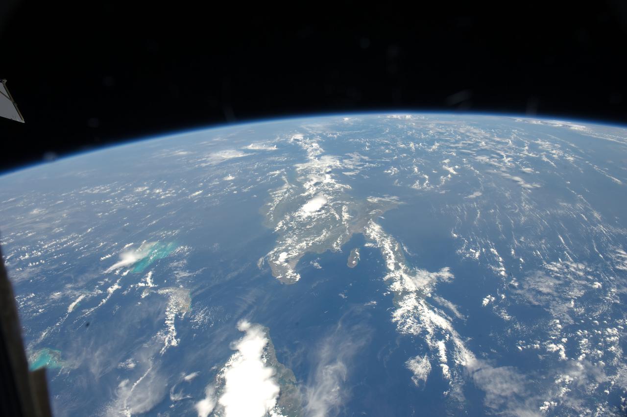 ISS032-E-008976 (15 July 2012) --- Saharan dust reaching the Americas is featured in this image photographed by an Expedition 32 crew member on the International Space Station. Weather satellites frequently document major dust palls blowing from the Sahara Desert westward from Africa out into the tropical Atlantic Ocean. Space station crew members frequently see these Saharan dust masses as very widespread atmospheric haze. Dust palls blowing from Africa can be transported right across the Atlantic Ocean.  It takes about a week to reach either North America (in northern hemisphere summer) or South America (in northern hemisphere winter). This puts the Caribbean basin on the receiving end of many of these events. Recently, researchers have linked Saharan dust to coral disease, allergic reactions in humans, and red tides. The margin of the hazy air in this image reaches as far as Haiti (top center) and the nearby Turks and Caicos Islands (top left) ? but the eastern tip of Cuba in the foreground remains in the clear air.