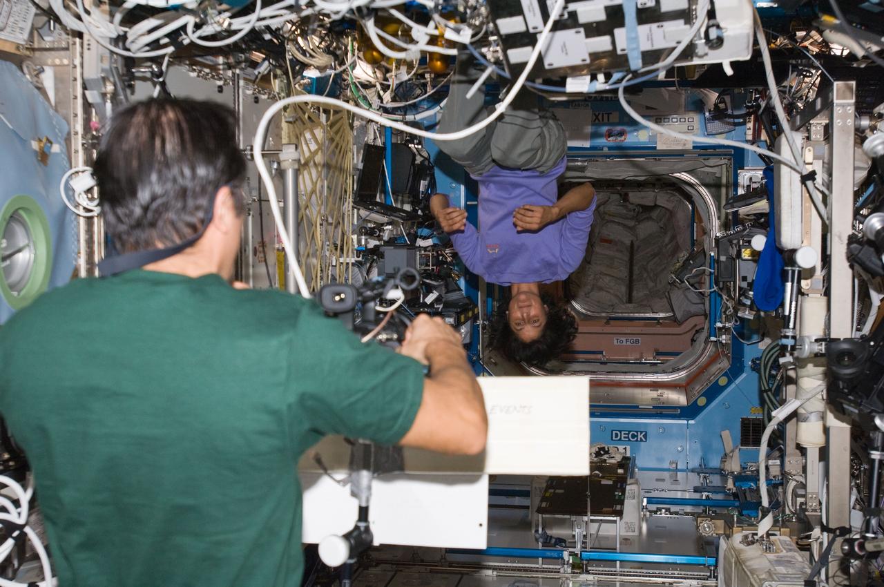 ISS032-E-009061 (25 July 2012) --- NASA astronauts Joe Acaba and Sunita Williams, both Expedition 32 flight engineers, perform video message recording in the Destiny laboratory of the International Space Station.