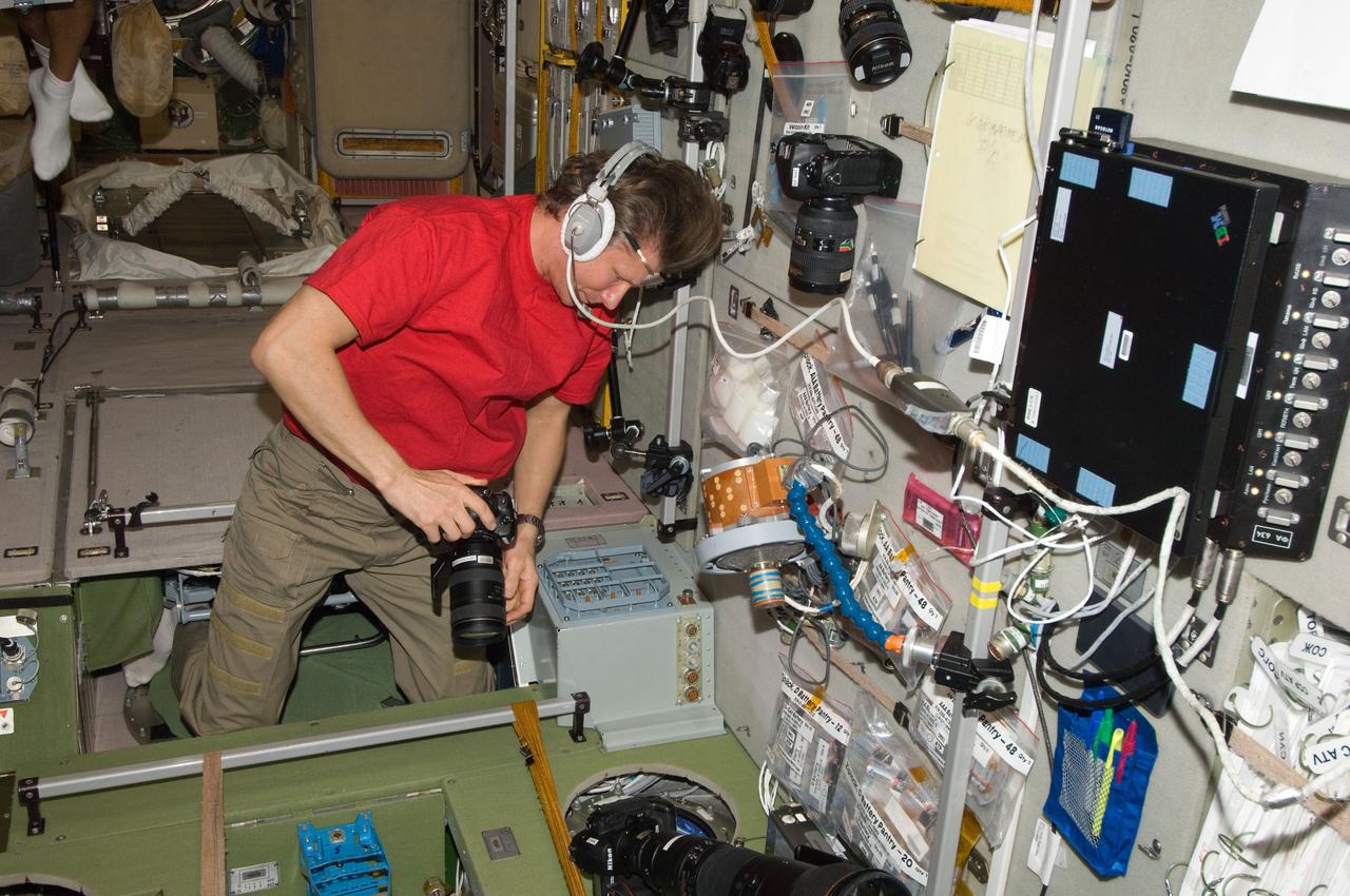 ISS032-E-010066 (22 July 2012) --- Russian cosmonaut Gennady Padalka, Expedition 32 commander, wearing a communication headset and holding a still camera, monitors the undocking of the unpiloted Progress 47 resupply spacecraft from a window in the Zvezda Service Module of the International Space Station. The Progress temporarily undocked from the station’s Pirs Docking Compartment on July 22, 2012 in order to perform a series of engineering tests during re-docking designed to verify an upgraded automated rendezvous system that will facilitate future dockings of Russian vehicles to the space station. Progress 47 separated from the station to a distance of about 100 miles and held position for 24 hours.
