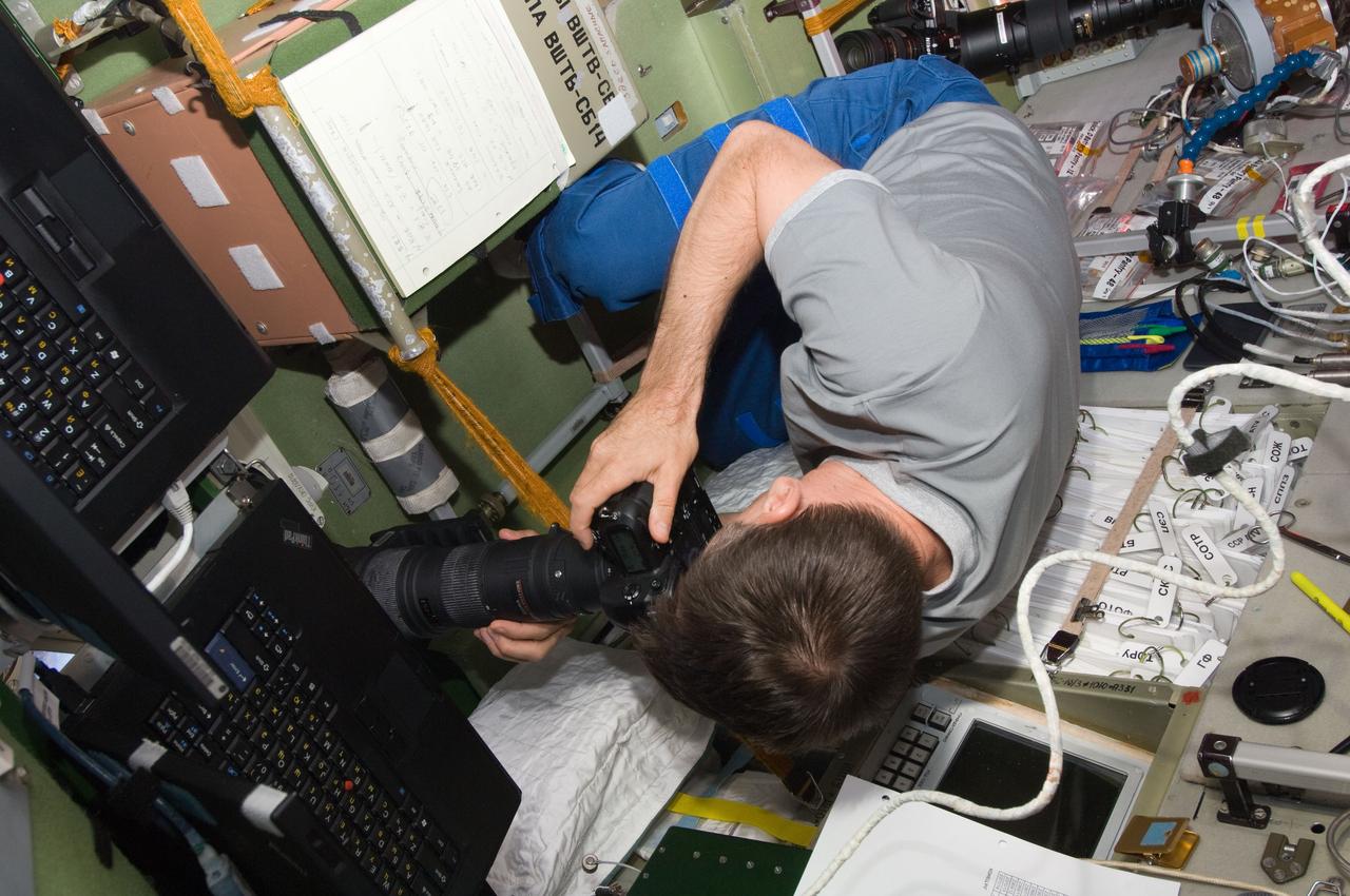 ISS032-E-010071 (22 July 2012) --- Russian cosmonaut Yuri Malenchenko, Expedition 32 flight engineer, uses a still camera at a window in the International Space Station’s Zvezda Service Module during undocking activities of the unpiloted Progress 47 resupply spacecraft. The Progress temporarily undocked from the station’s Pirs Docking Compartment on July 22, 2012 in order to perform a series of engineering tests during re-docking designed to verify an upgraded automated rendezvous system that will facilitate future dockings of Russian vehicles to the space station. Progress 47 separated from the station to a distance of about 100 miles and held position for 24 hours.