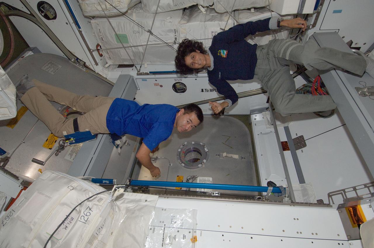 ISS032-E-010317 (27 July 2012) --- Japan Aerospace Exploration Agency astronaut Aki Hoshide and NASA astronaut Sunita Williams, both Expedition 32 flight engineers, are pictured near a hatch in the Harmony node of the International Space Station.