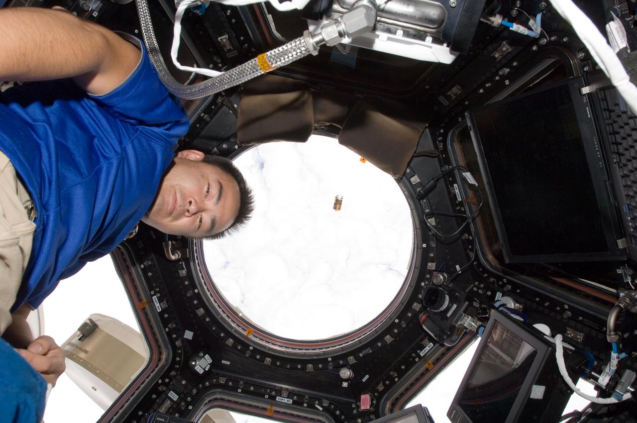 ISS032-E-010583 (27 July 2012) --- Japan Aerospace Exploration Agency astronaut Aki Hoshide is pictured near the windows in the International Space Station?s Cupola as the unpiloted Japan Aerospace Exploration Agency (JAXA) H-II Transfer Vehicle (HTV-3) approaches the station. Hoshide and NASA astronaut Joe Acaba (out of frame), both Expedition 32 flight engineers, used the station's Canadarm2 robotic arm to capture and berth the HTV-3 to the Earth-facing port of the station's Harmony node. The attachment was completed at 10:34 a.m. (EDT) on July 27, 2012.