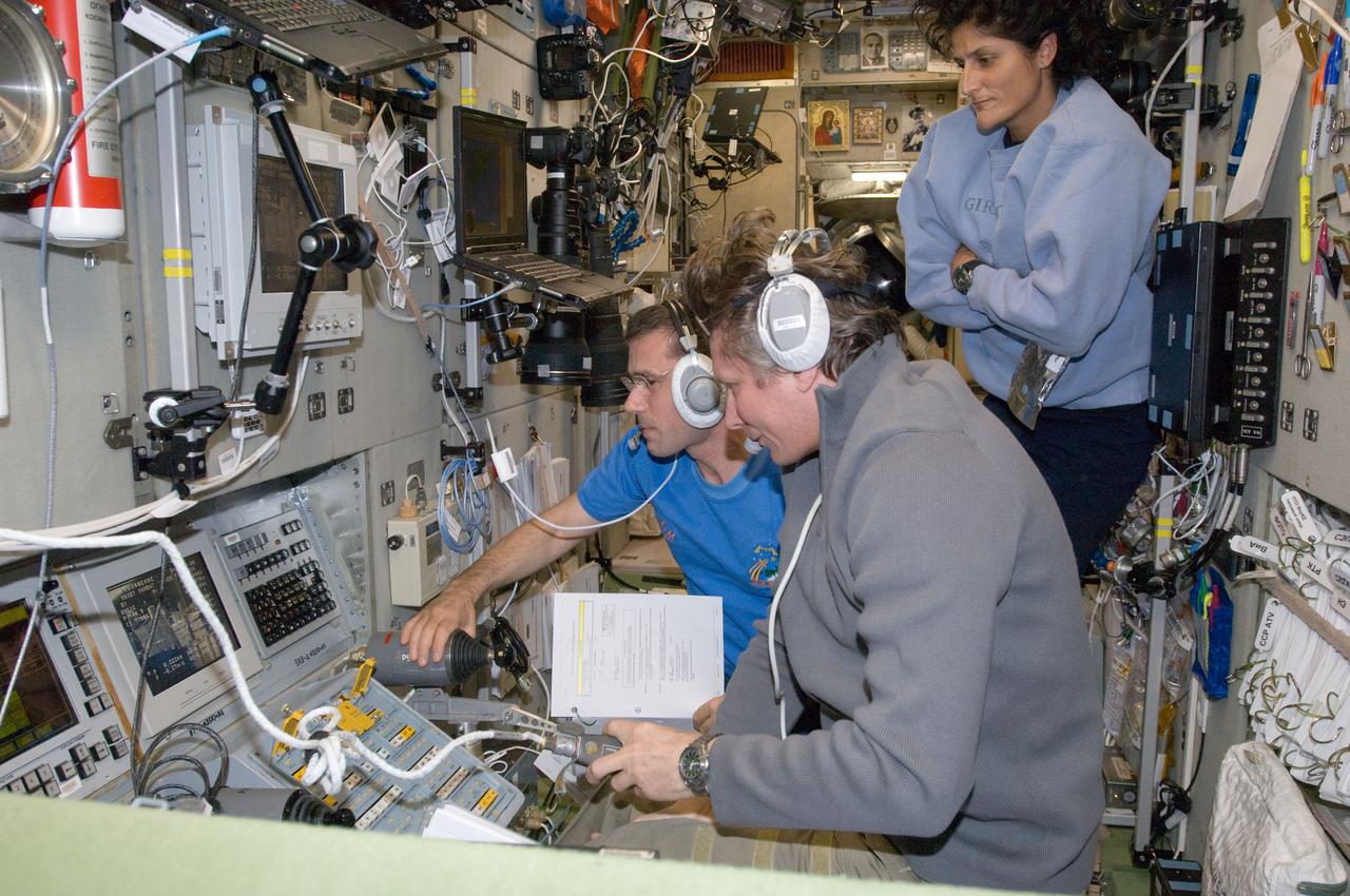ISS032-E-010632 (28 July 2012) --- Russian cosmonauts Gennady Padalka (foreground), Expedition 32 commander; and Yuri Malenchenko, flight engineer, monitor data at the manual TORU docking system controls in the Zvezda Service Module of the International Space Station during approach and re-docking operations of the unpiloted Progress 47 resupply vehicle on July 28, 2012. The Progress temporarily undocked from the station?s Pirs Docking Compartment on July 22 in order to perform a series of engineering tests during re-docking designed to verify an upgraded automated rendezvous system that will facilitate future dockings of Russian vehicles to the space station. The cargo ship re-docked at 9:01 p.m. (EDT) on July 28 in a test of the new Kurs-NA automated rendezvous system. NASA astronaut Sunita Williams, flight engineer, looks on.