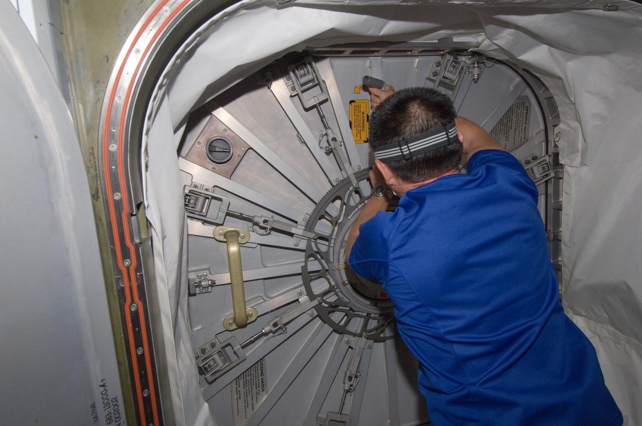 ISS032-E-011394 (28 July 2012) --- Japan Aerospace Exploration Agency astronaut Aki Hoshide, Expedition 32 flight engineer, prepares to open the hatch to the newly attached Japan Aerospace Exploration Agency (JAXA) H-II Transfer Vehicle (HTV-3) docked to the International Space Station’s Harmony node.