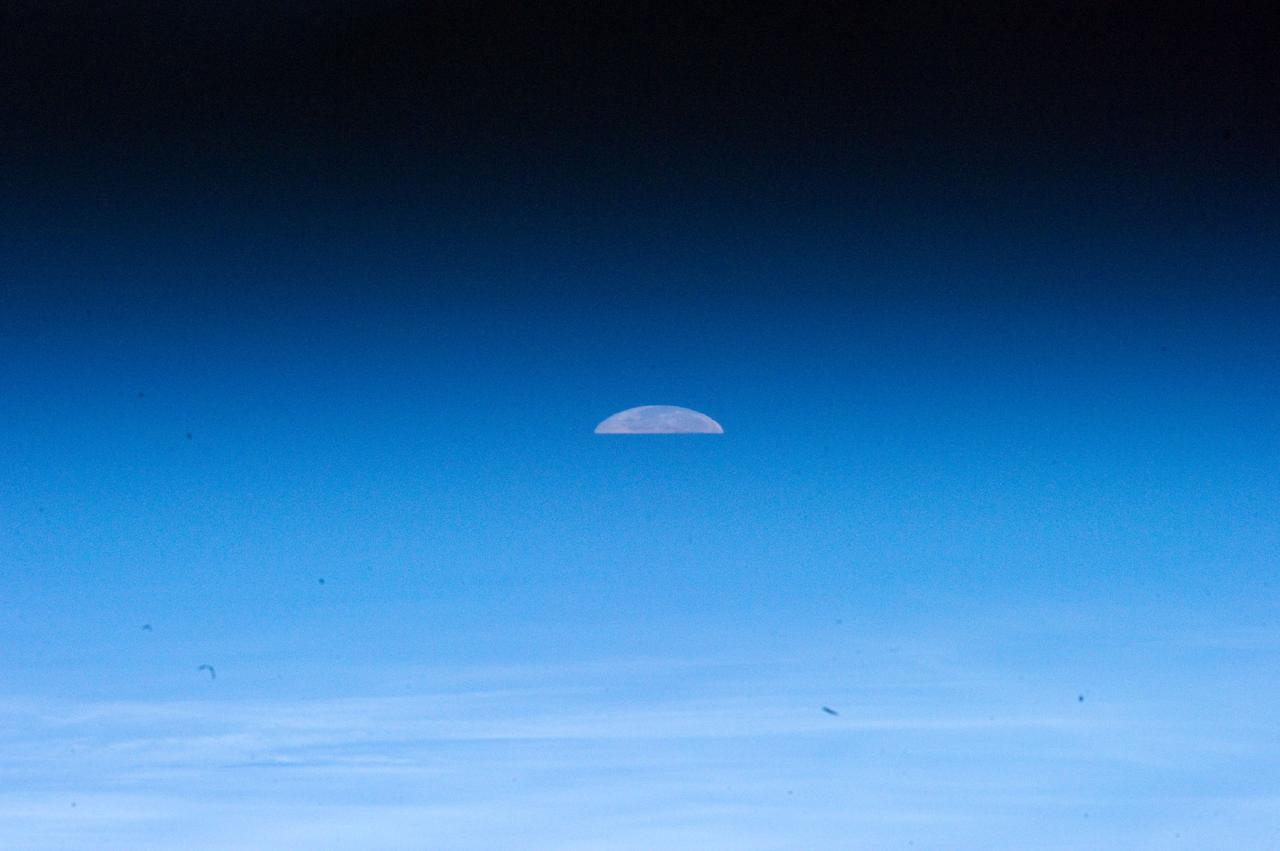 ISS032-E-011478 (1 Aug. 2012) --- One of the Expedition 32 crew members aboard the Earth-orbiting International Space Station captured  this image of the full moon on Aug. 1, 2012.  Because of the home planet's atmosphere, it is not easy at first sighting to recognize the slice as the full moon. Another picture in this series depicts a totally different image of Earth's natural satellite because of the lack of distortion caused by the atmosphere.