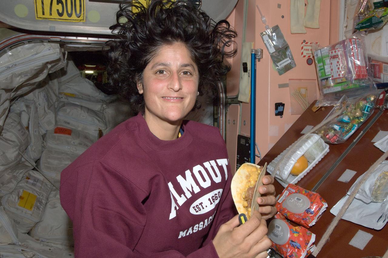 ISS032-E-011884 (5 Aug. 2012) --- NASA astronaut Sunita Williams, Expedition 32 flight engineer, prepares to eat a snack near the galley in the Unity node of the International Space Station.