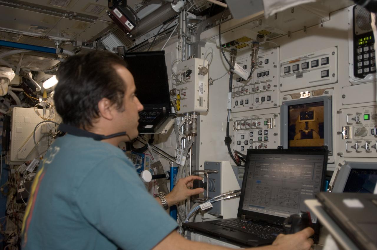 ISS032-E-014904 (9 Aug. 2012) --- NASA astronaut Joe Acaba, Expedition 32 flight engineer, works the controls of the Japanese Experiment Module Remote Manipulator System (JEMRMS) in the Kibo laboratory of the International Space Station.