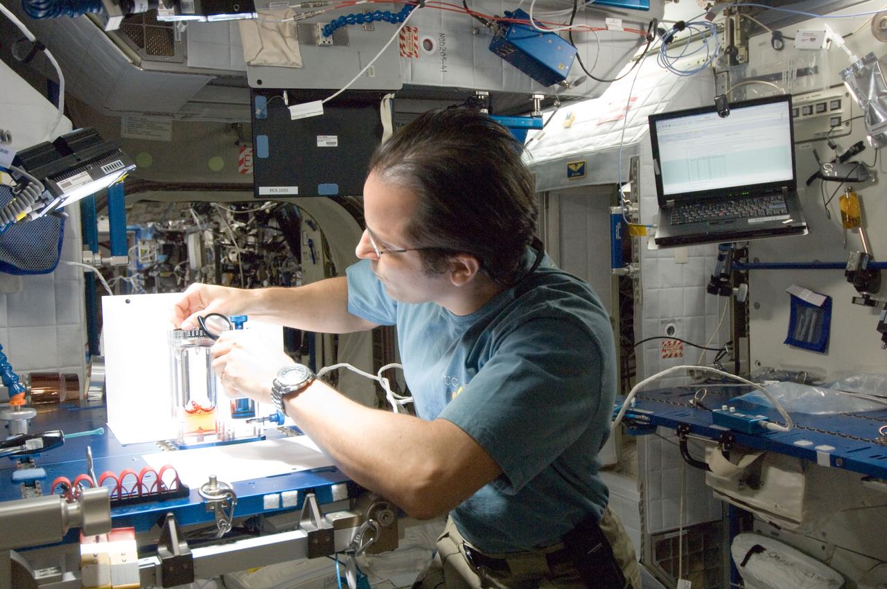 ISS032-E-016961 (10 Aug. 2012) --- NASA astronaut Joe Acaba, Expedition 32 flight engineer, conducts a session with the Capillary Flow Experiment (CFE) Vane Gap-2 (VG2) in the Harmony node of the International Space Station. CFE observes the flow of fluid, in particular capillary phenomena, in microgravity.