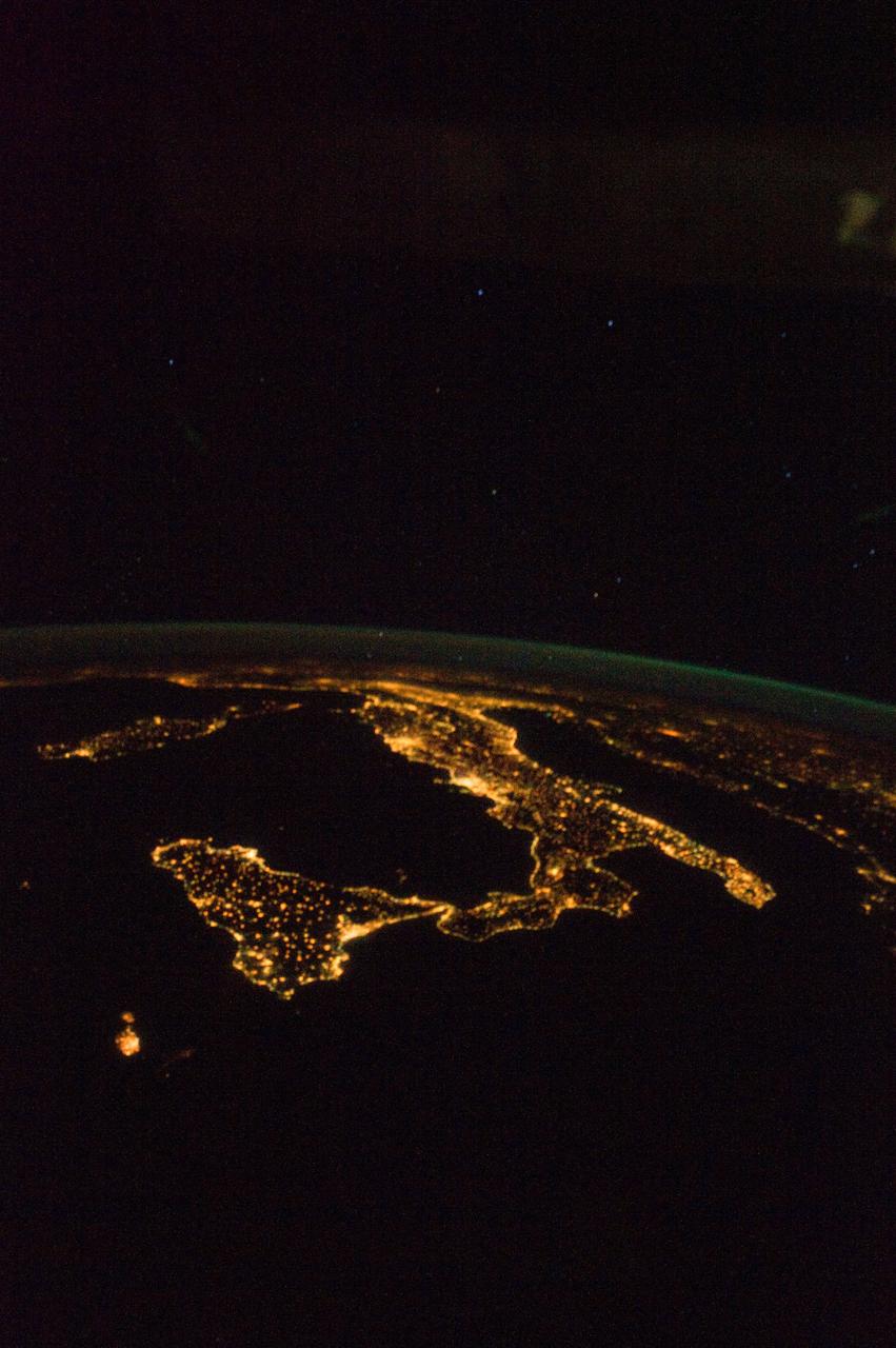 ISS032-E-020159 (18 Aug. 2012 ) --- This oblique, nighttime panorama of much of Europe was photographed by one of the Expedition 32 crew members aboard the International Space Station flying approximately 240 miles above the Mediterranean Sea on Aug. 18, 2012. The country of Italy is visible running diagonally southward from the horizon across the center of the frame, with the night lights of Rome and Naples being visible on the coast near the center. Sardinia and Corsica are just above left center of the photo, and Sicily is at lower left. The Adriatic Sea is on the other side of Italy, and beyond it to the east and north can be seen parts of several other European nations.