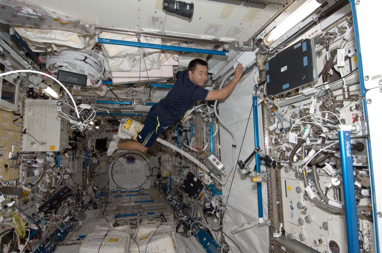 ISS032-E-020520 (28 July 2012) --- Japan Aerospace Exploration Agency astronaut Aki Hoshide, Expedition 32 flight engineer, uses a vacuum cleaner during housekeeping operations in the Kibo laboratory of the International Space Station.