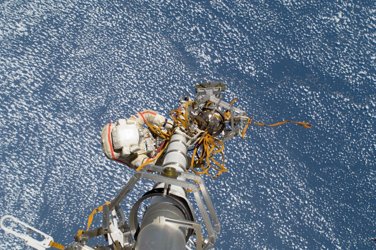 ISS032-E-020581 (20 Aug. 2012) --- Russian cosmonaut Gennady Padalka, Expedition 32 commander, participates in a session of extravehicular activity (EVA) to continue outfitting the International Space Station. During the five-hour, 51-minute spacewalk, Padalka and Russian cosmonaut Yuri Malenchenko (out of frame), flight engineer, moved the Strela-2 cargo boom from the Pirs docking compartment to the Zarya module to prepare Pirs for its eventual replacement with a new Russian multipurpose laboratory module. The two spacewalking cosmonauts also installed micrometeoroid debris shields on the exterior of the Zvezda service module and deployed a small science satellite.