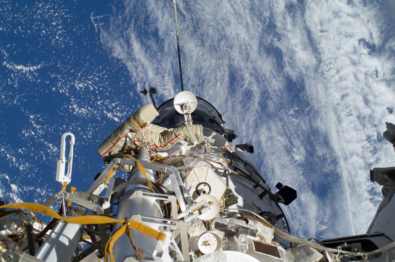 ISS032-E-020594 (20 Aug. 2012) --- Russian cosmonaut Gennady Padalka, Expedition 32 commander, participates in a session of extravehicular activity (EVA) to continue outfitting the International Space Station. During the five-hour, 51-minute spacewalk, Padalka and Russian cosmonaut Yuri Malenchenko (out of frame), flight engineer, moved the Strela-2 cargo boom from the Pirs docking compartment to the Zarya module to prepare Pirs for its eventual replacement with a new Russian multipurpose laboratory module. The two spacewalking cosmonauts also installed micrometeoroid debris shields on the exterior of the Zvezda service module and deployed a small science satellite.