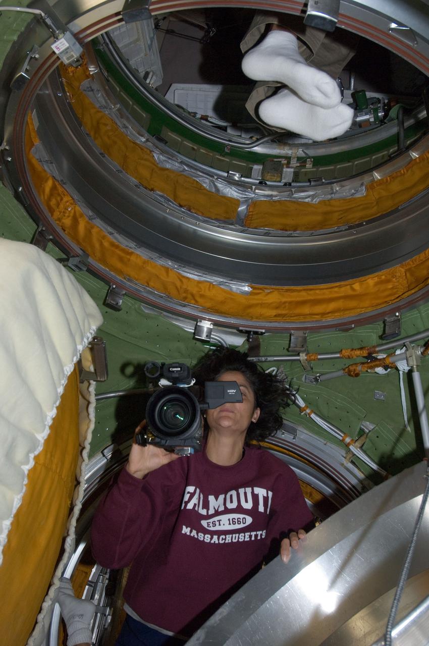 ISS032-E-020798 (20 Aug. 2012) --- NASA astronaut Sunita Williams, Expedition 32 flight engineer, uses a High Definition Video (HDV) camera in the transfer compartment between the Zarya Functional Cargo Block (FGB) and the Zvezda Service Module of the International Space Station.