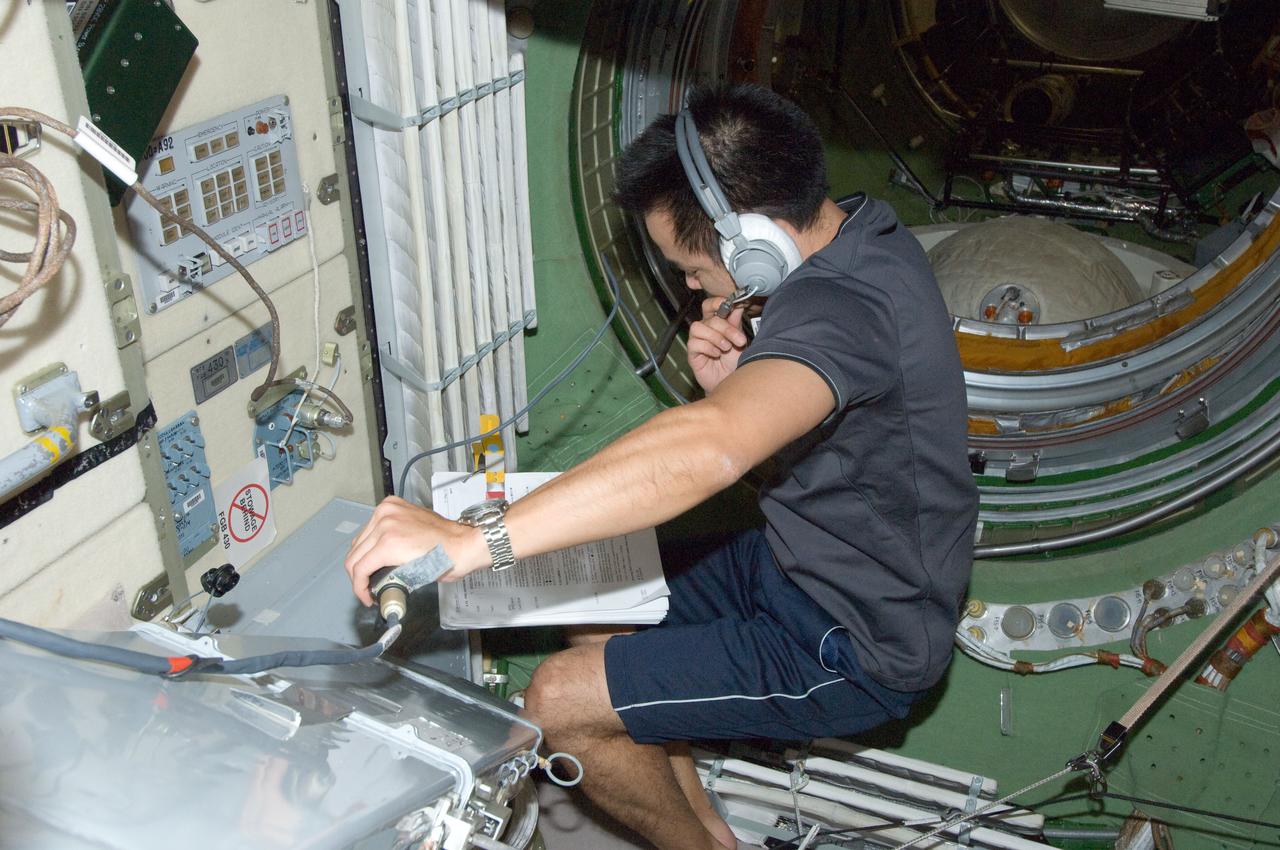 ISS032-E-020817 (20 Aug. 2012) --- Japan Aerospace Exploration Agency astronaut Aki Hoshide, Expedition 32 flight engineer, wearing a communication headset, works in the Zarya Functional Cargo Block (FGB) of the International Space Station.