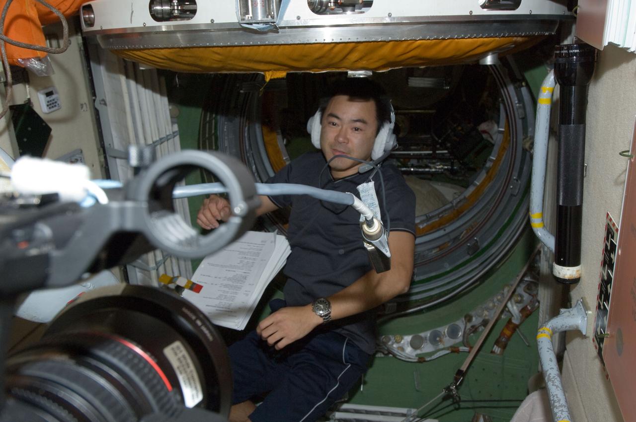 ISS032-E-020818 (20 Aug. 2012) --- Japan Aerospace Exploration Agency astronaut Aki Hoshide, Expedition 32 flight engineer, wearing a communication headset, works in the Zarya Functional Cargo Block (FGB) of the International Space Station.