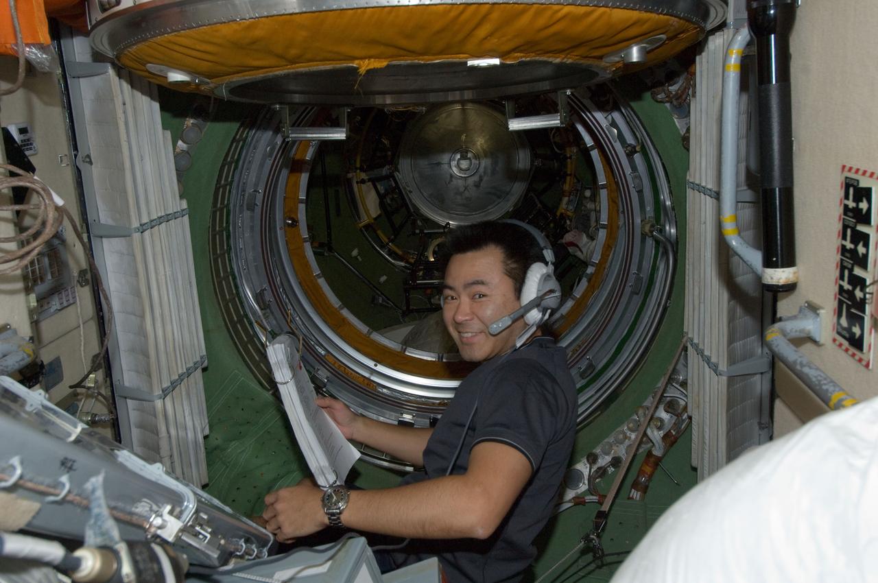 ISS032-E-020821 (20 Aug. 2012) --- Japan Aerospace Exploration Agency astronaut Aki Hoshide, Expedition 32 flight engineer, wearing a communication headset, works in the Zarya Functional Cargo Block (FGB) of the International Space Station.